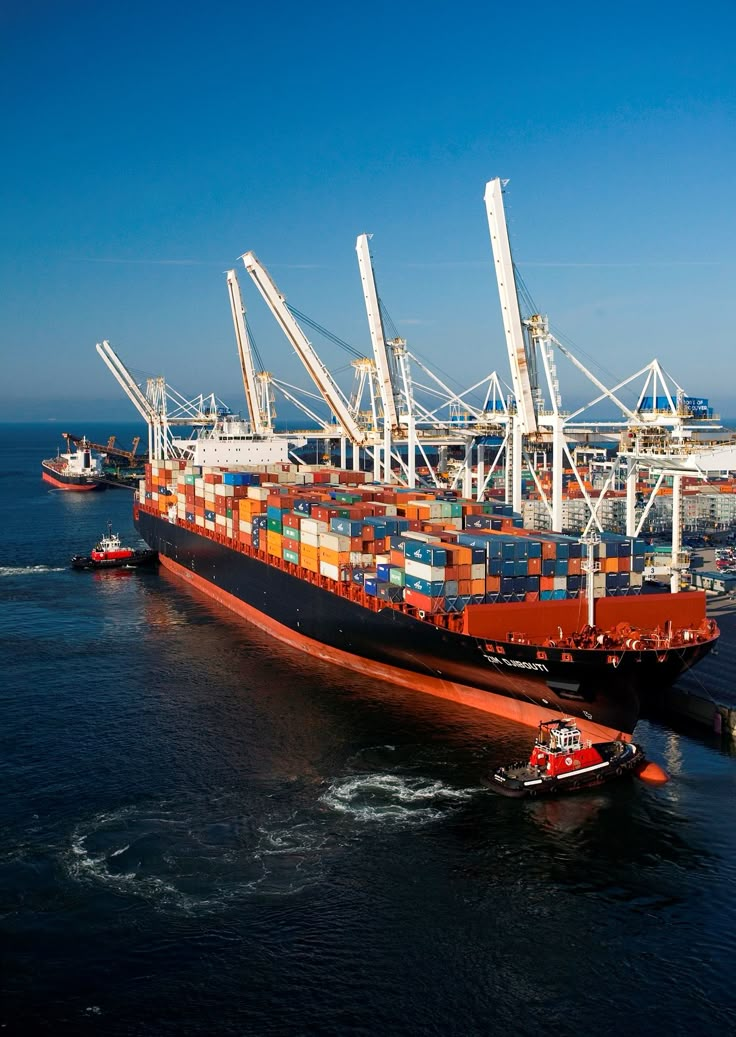 Container ship berthed at a port with cranes